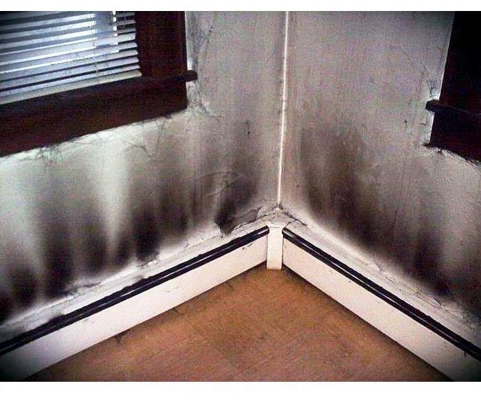 Soot and oil causing black marks up white walls - the effect of a puff back.